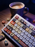 Bangboo Zenless Zone Zero keycap set on a matte wood desk with coffee, Midnight Atelier lighting