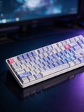 Columbina Genshin Impact keycap set with monitor bokeh behind